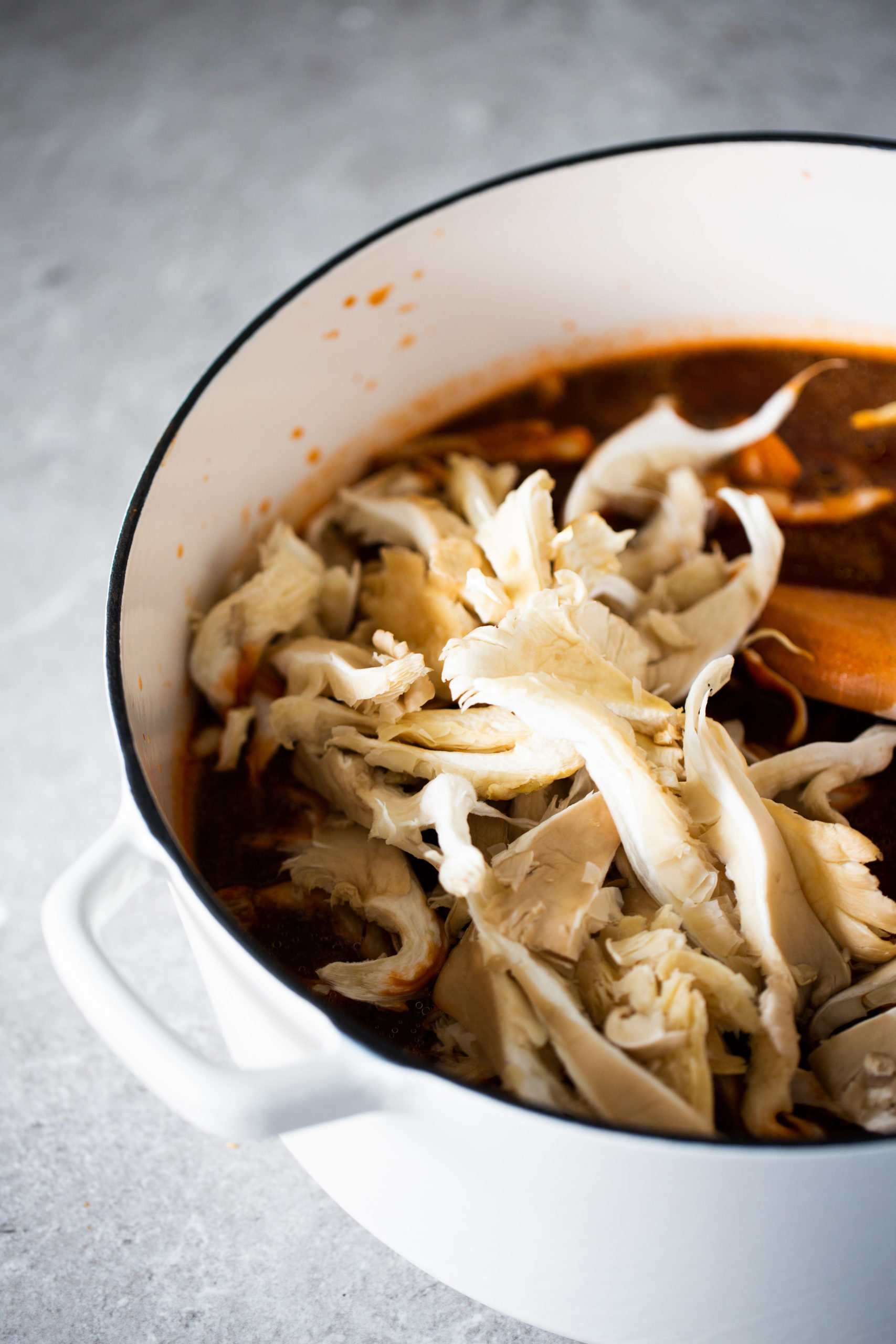 A vegan bowl of posole soup with shredded cabbage.