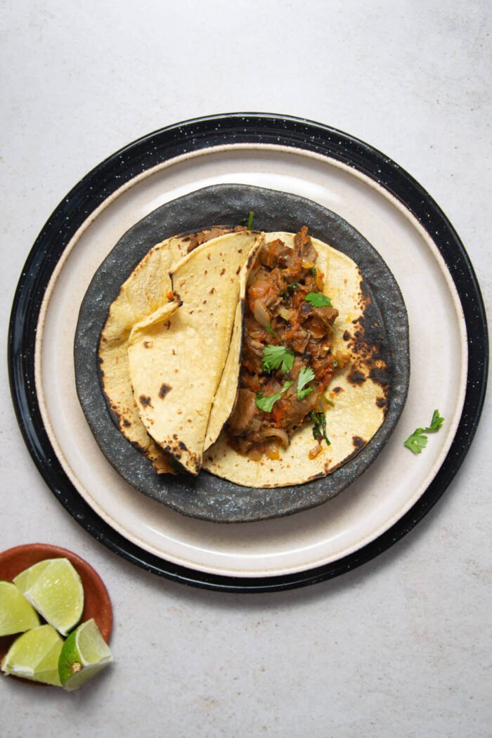 tacos de bistec a la mexicana sobre una pila de tres platos